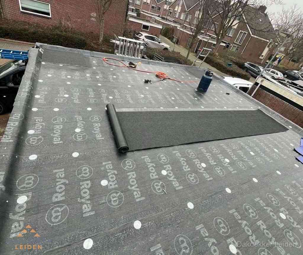 Dakdekker aan het werk met gasbrander op plat bitumen dak in Leiden Dakdekker aan het werk met gasbrander op plat bitumen dak in Leiden